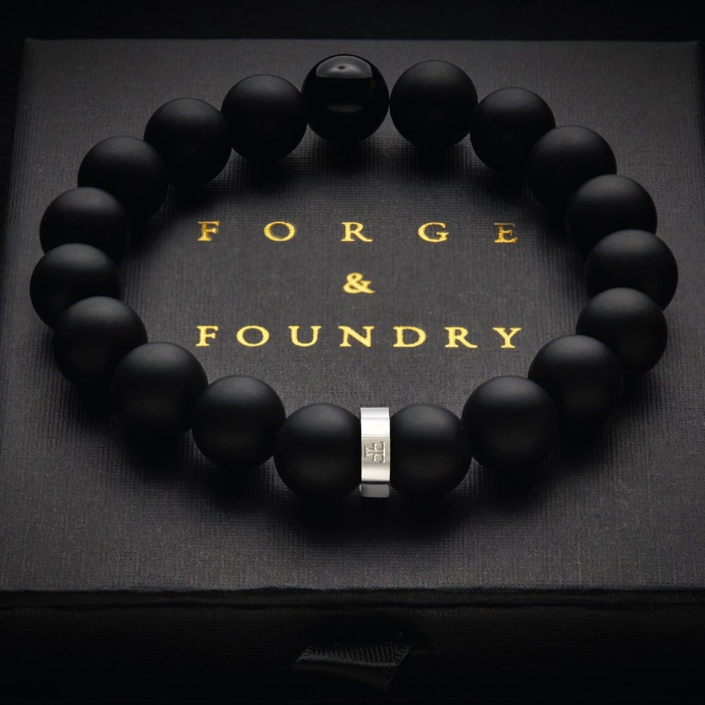 Men's 10mm black onyx beaded bracelet on packaging