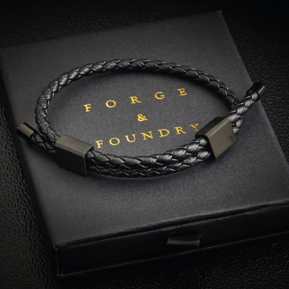 Men's black double clasp adjustable leather bracelet on packaging