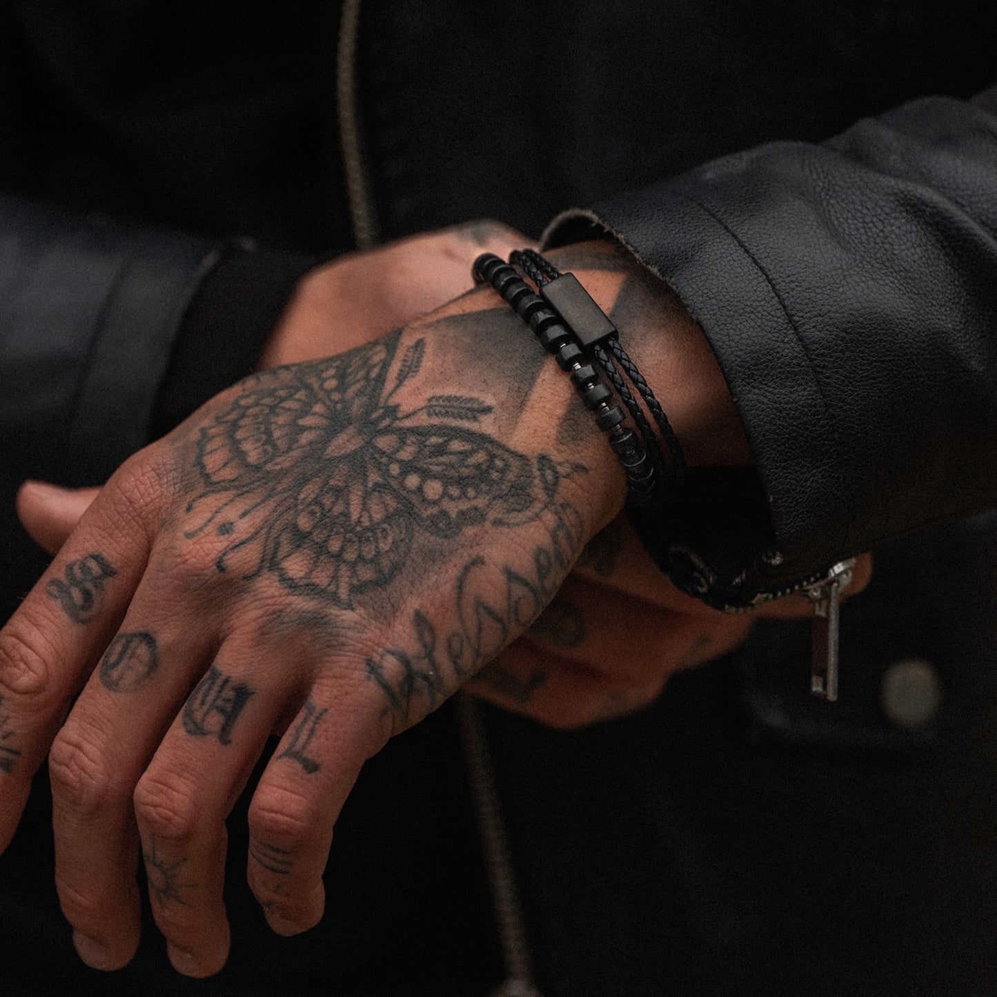 Mens minimalist black adjustable leather bracelet on model