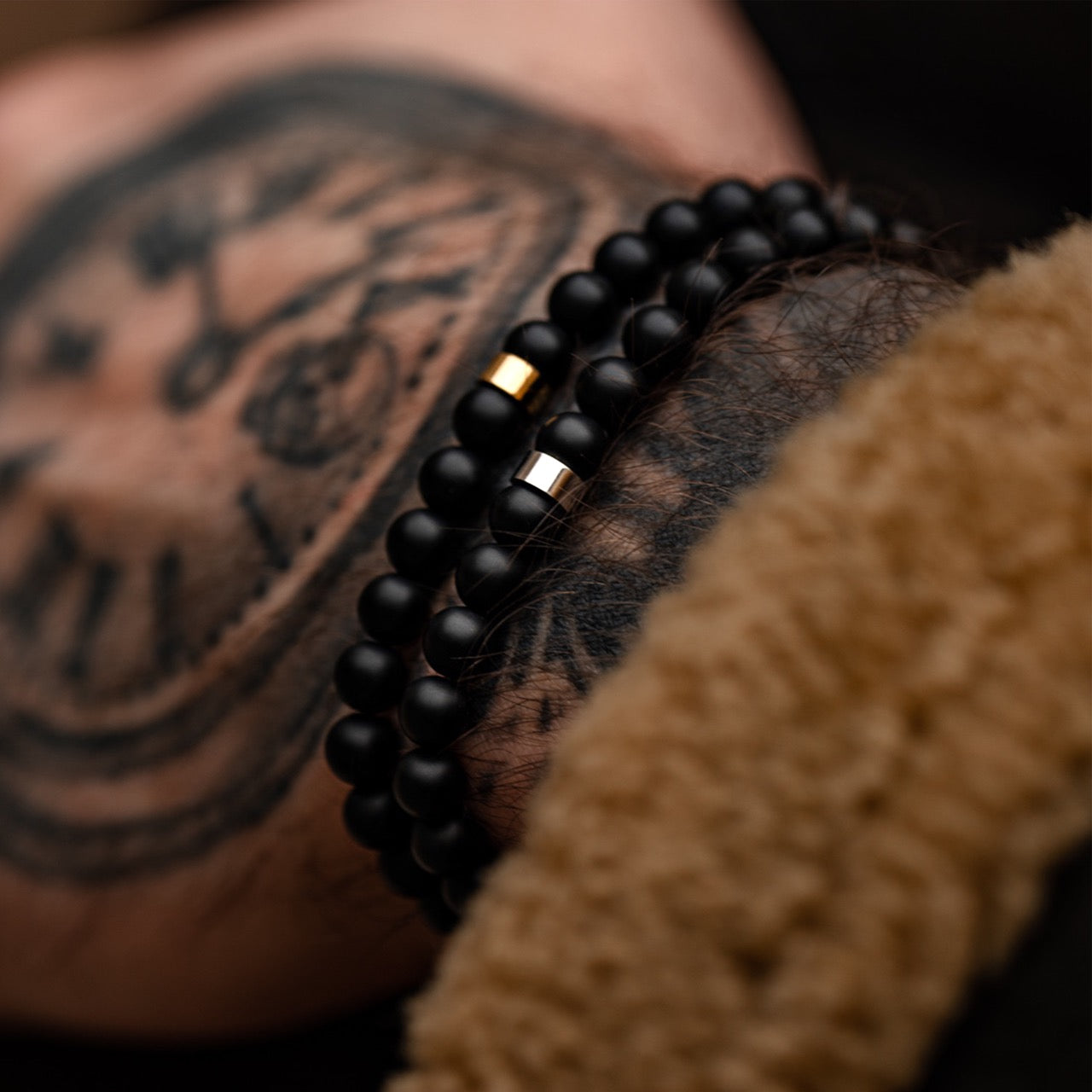 mens 6mm black and gold beaded stone bracelet on model