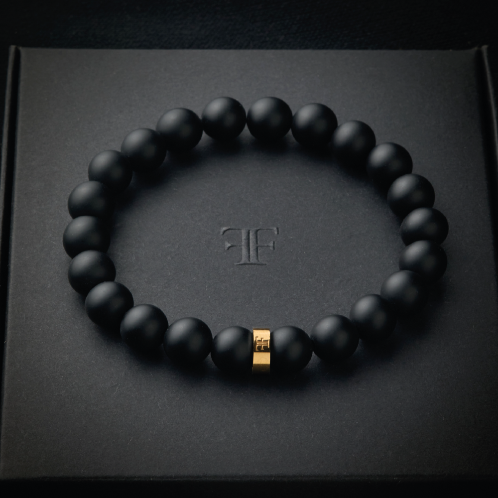 mens 8mm black and gold beaded stone bracelet on packaging