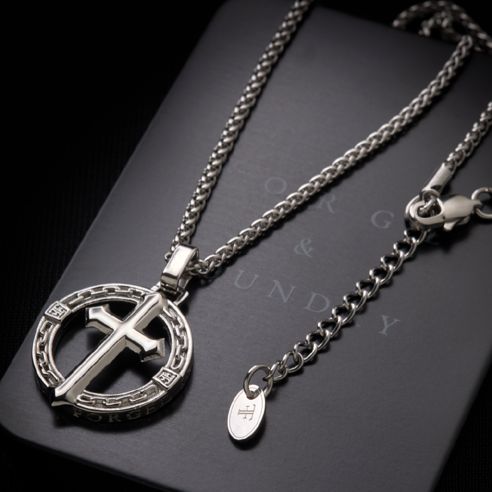 Men's silver stainless steel religious cross pendant on packaging tin