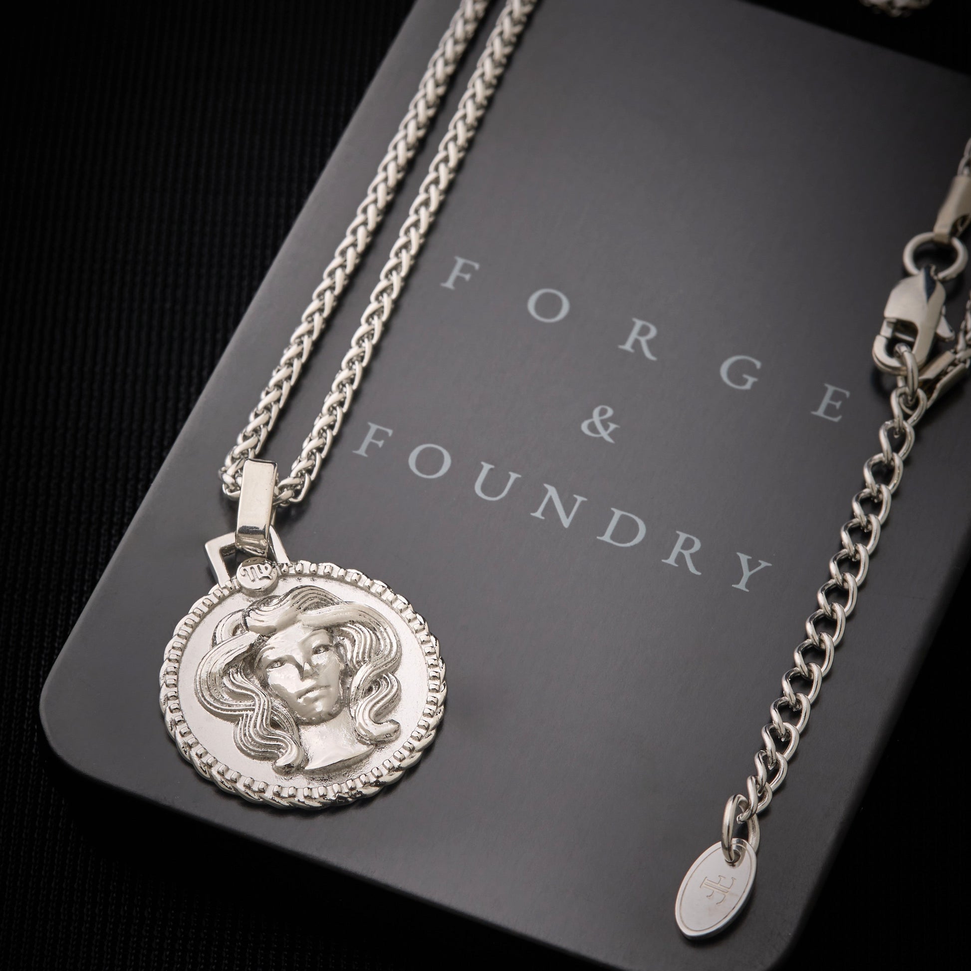 Men's silver Virgo pendant necklace on packaging box