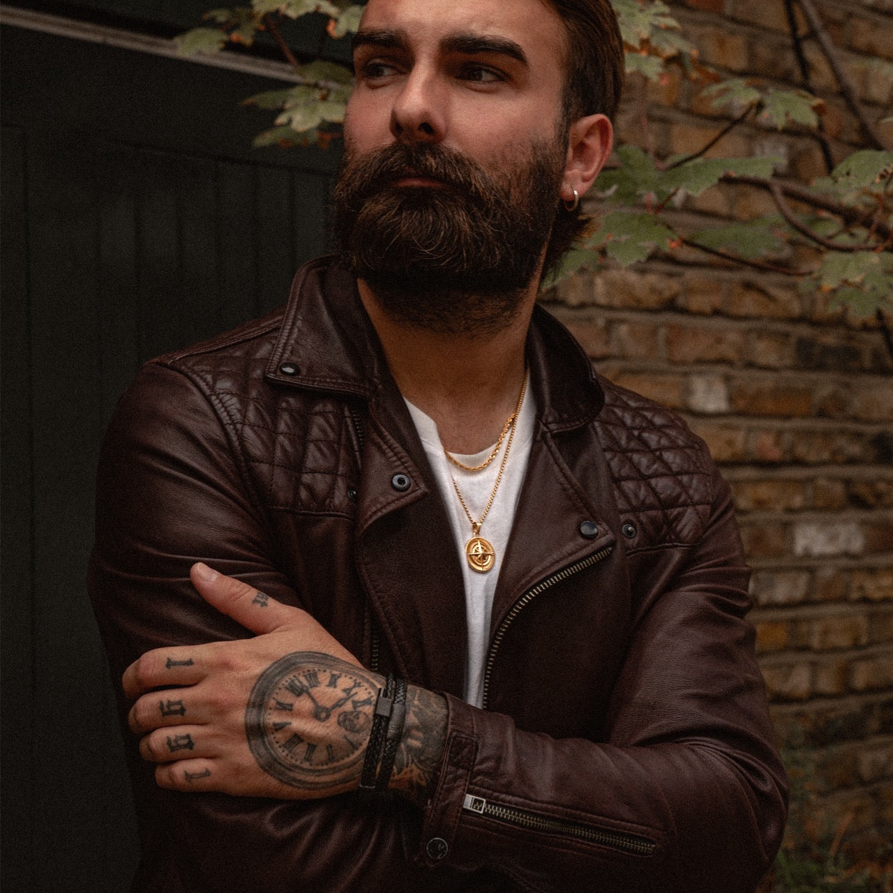 Men's gold compass pendant and rope chain necklace on model