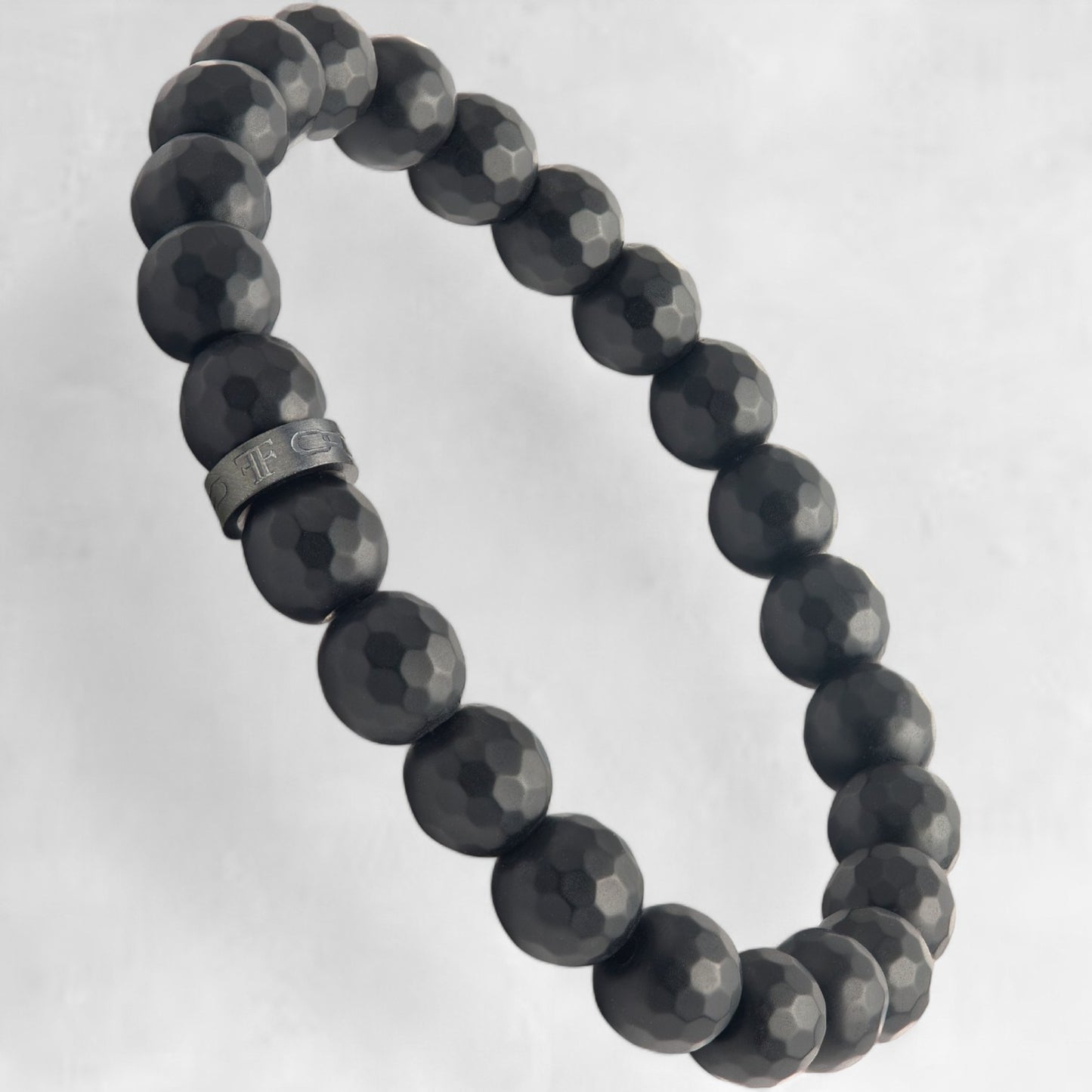 Men's black faceted onyx bead bracelet with black accent bead