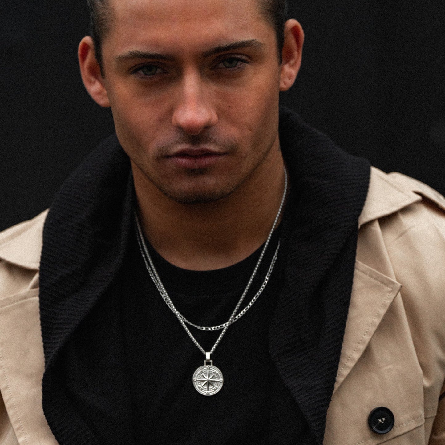 Men's silver compass pendant necklace on model