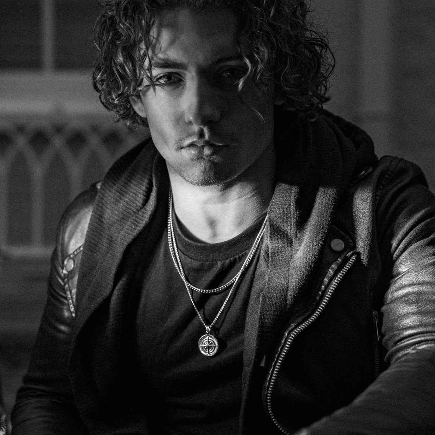 Men's silver compass pendant necklace on model