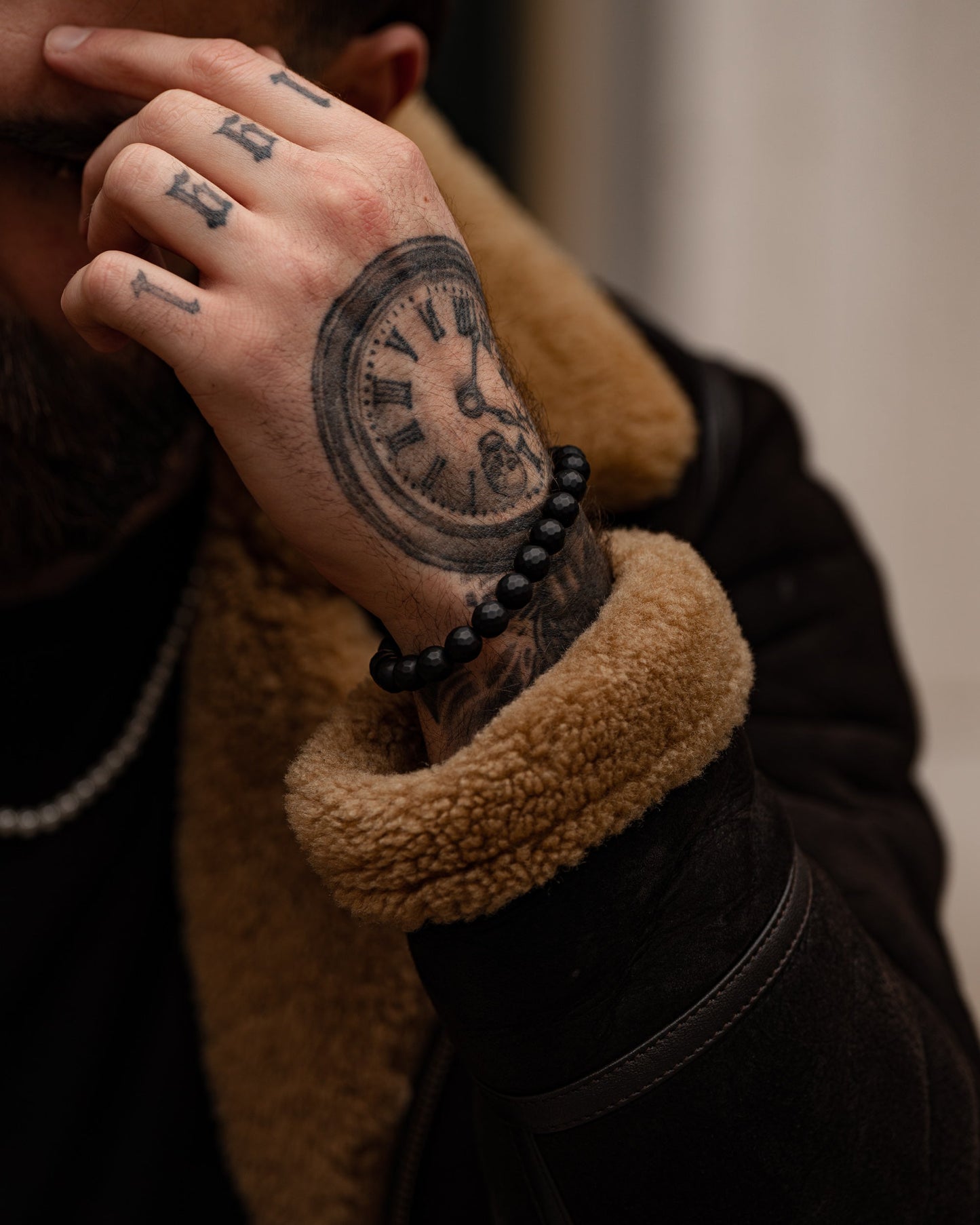 Men's faceted onyx bead bracelet on model