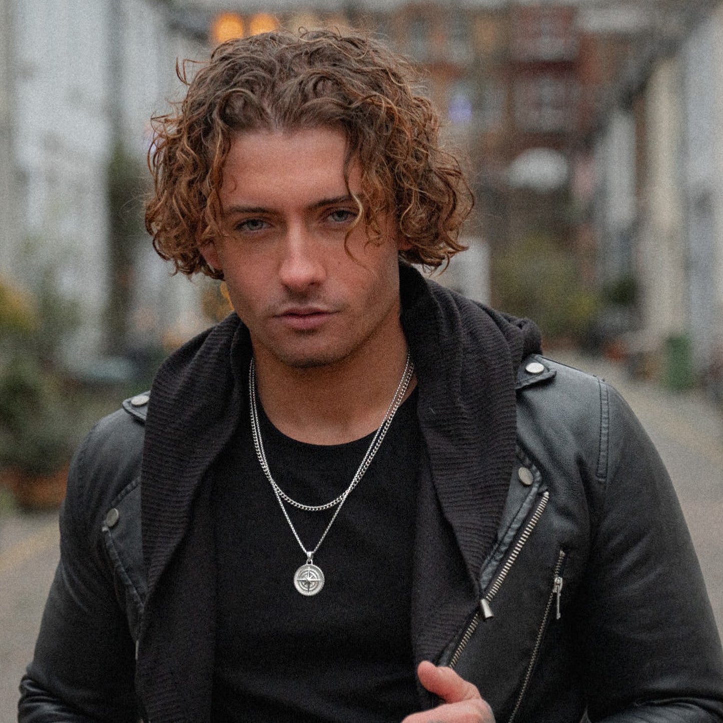 Men's silver compass pendant necklace on model