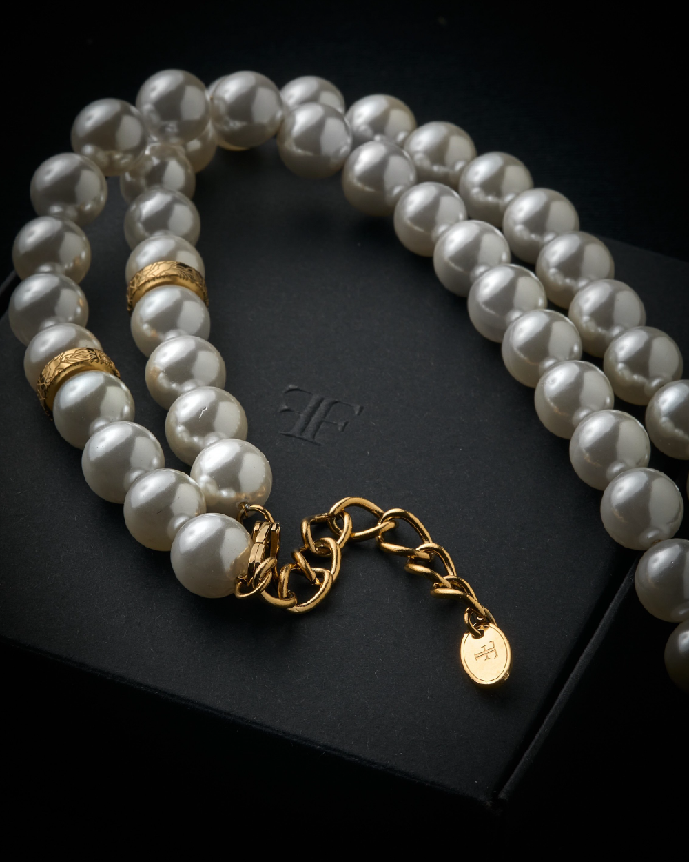 Mens shell pearl necklace with gold clasp on the packaging