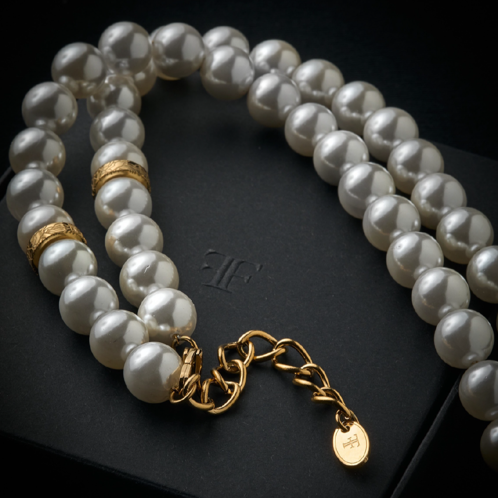 Mens shell pearl necklace with gold clasp on the packaging