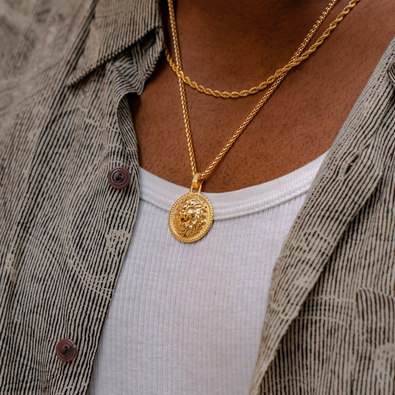 Men's gold plated lion pendant on model