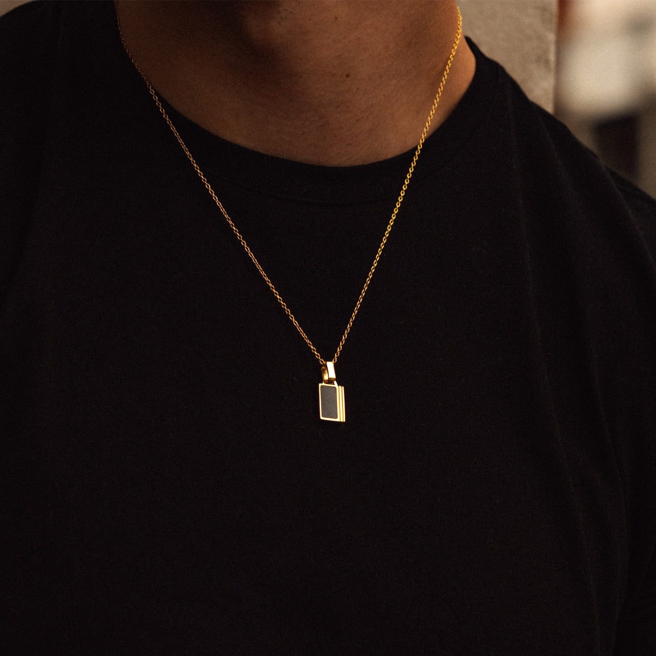 Men's gold onyx inlay pendant necklace on model