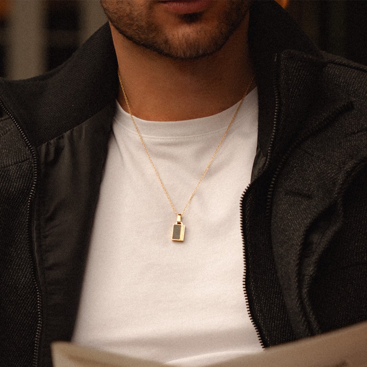 Men's gold onyx inlay pendant necklace on model