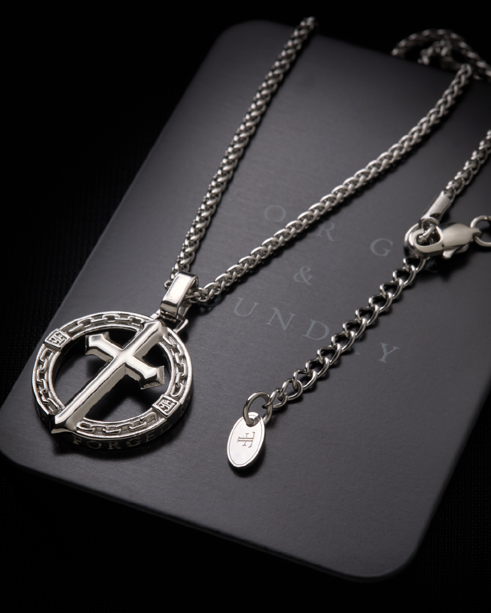 Men's silver stainless steel religious cross pendant on packaging tin
