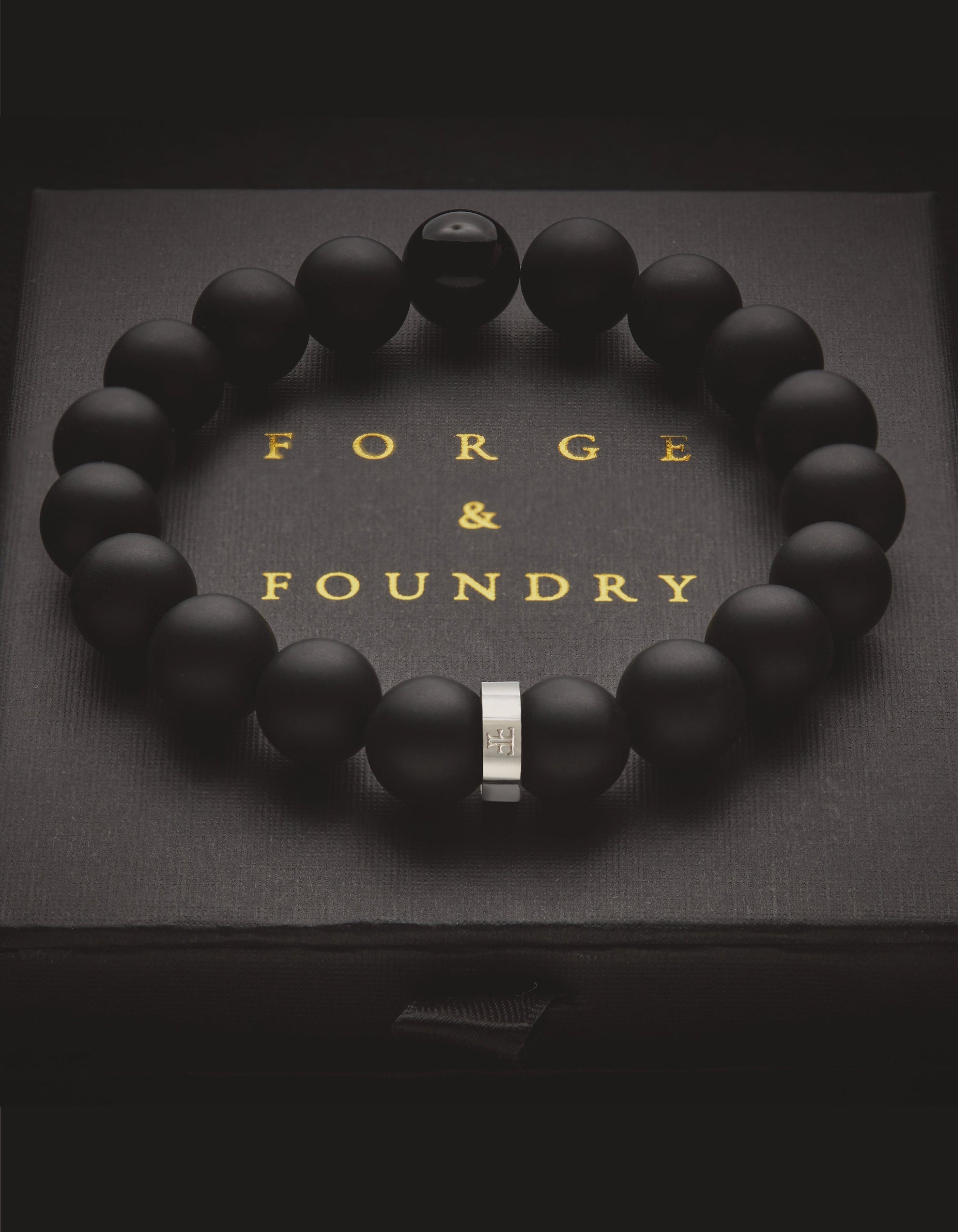Mens silver and black onyx bead and stone bracelet on the packaging