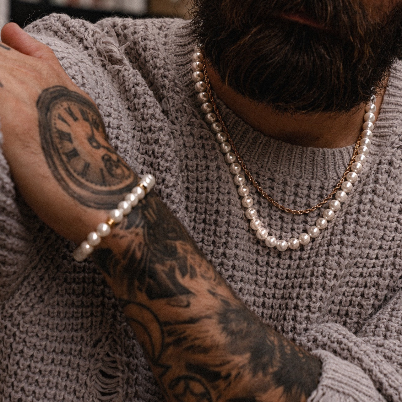 Men's gold rope chain necklace, pearl necklace and pearl bracelet on model