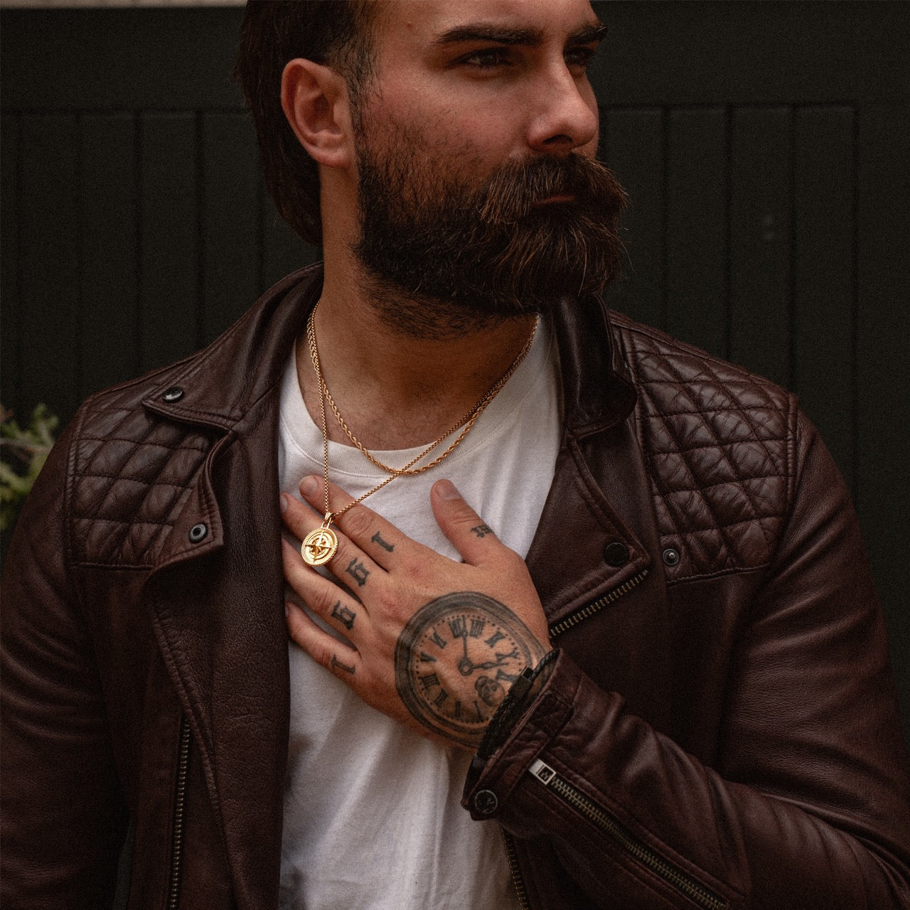 Men's gold rope chain necklace and compass pendant on model