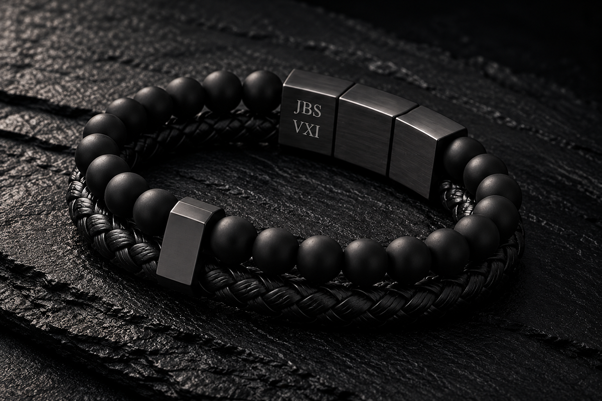 Personalised Valen bracelet hand-engraved with initials and Roman numerals, on dark stone