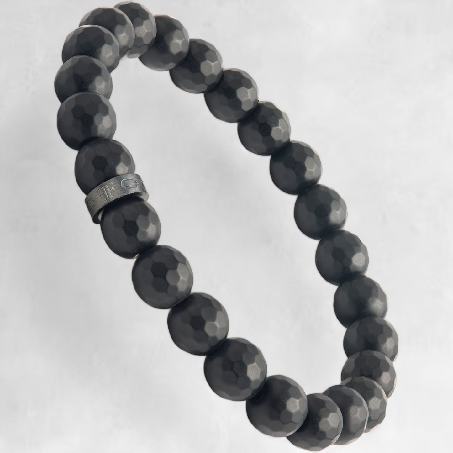 Men's black faceted onyx bead bracelet with black accent bead