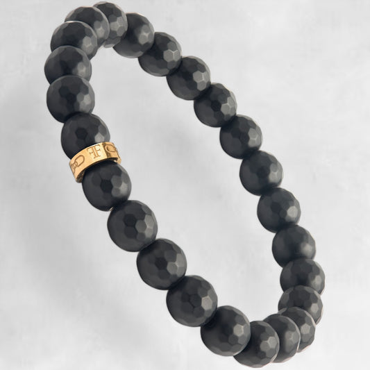 Men's faceted black onyx bead bracelet with gold accent bead